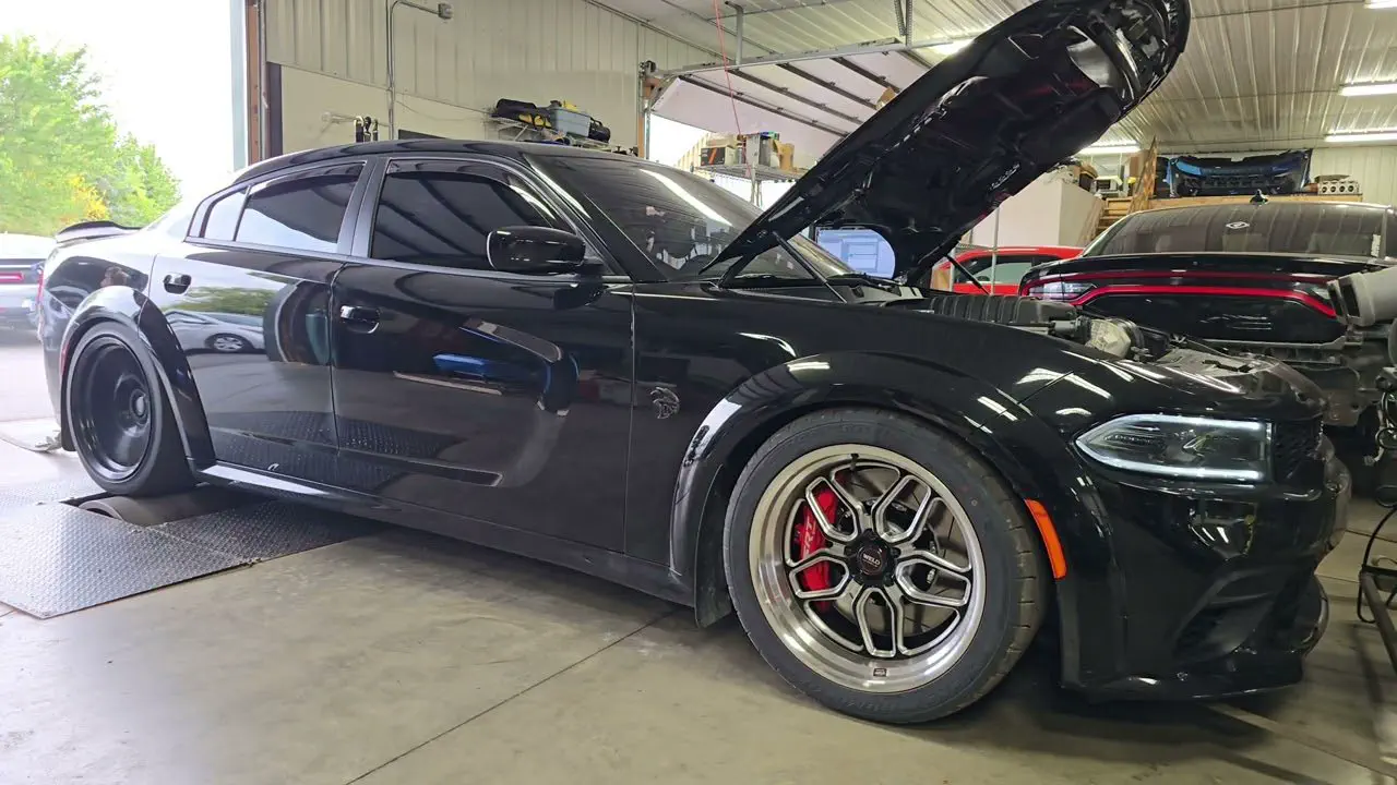 Black Dodge on the Satera Tuning dyno with the hood up